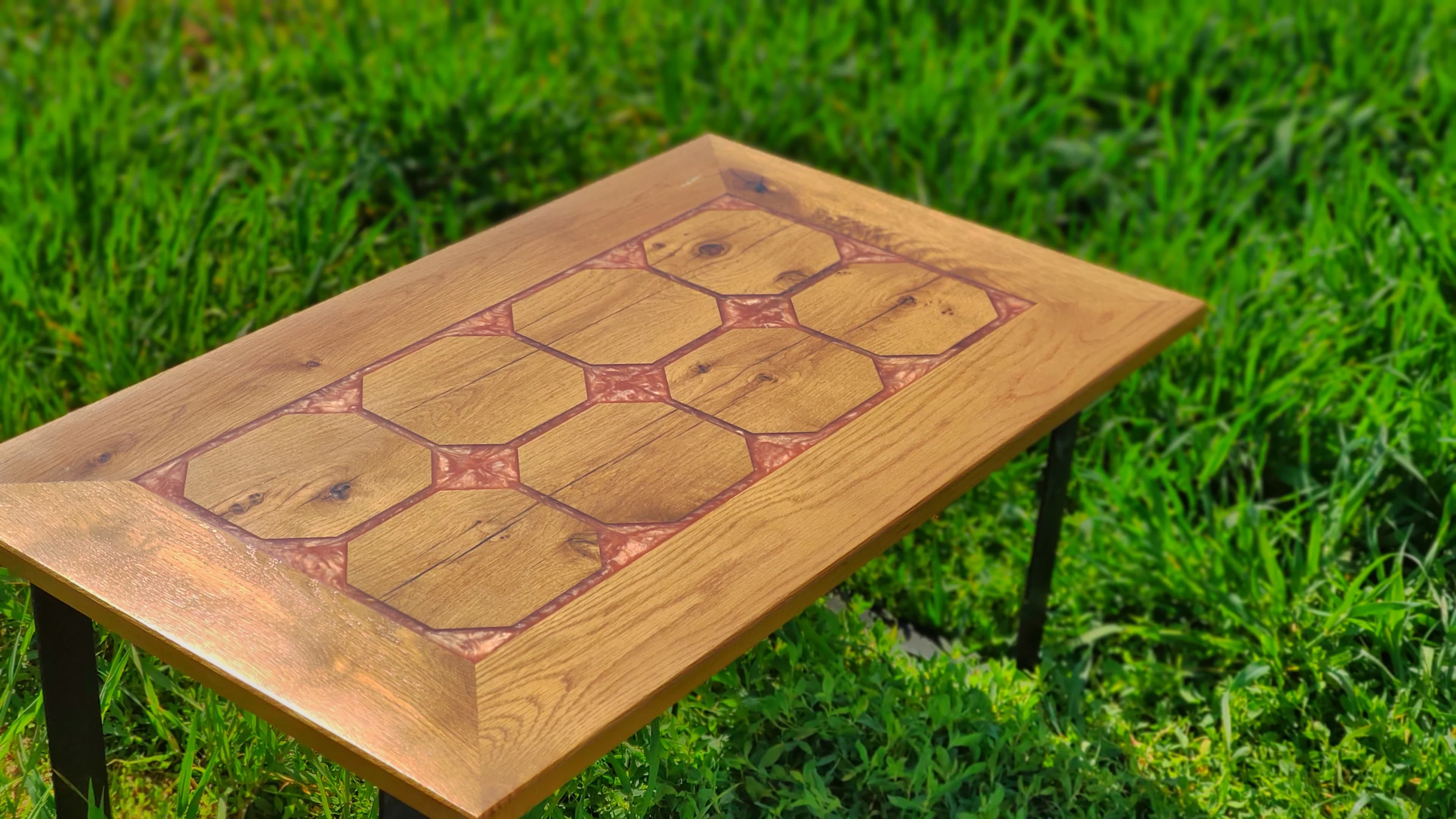 Mesa de centro con mosaico de baldosas octogonales de roble y resina cobriza metalizada al sol